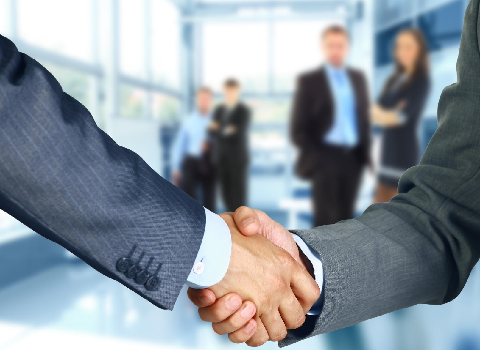 Website Design business associates shaking hands in office